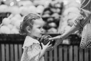 girl being handed cabbage